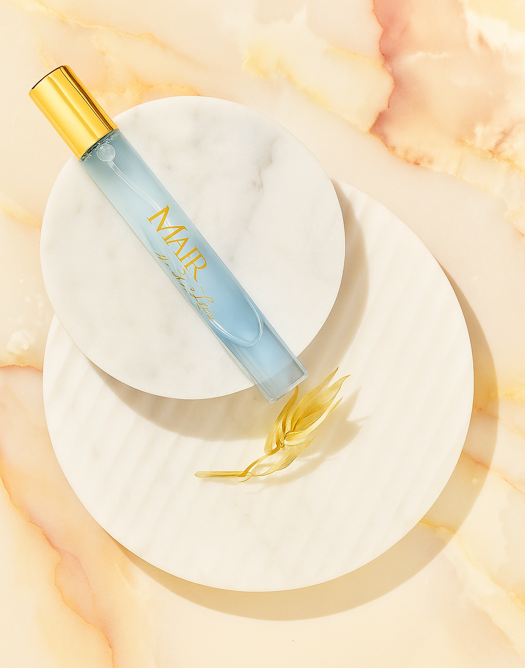 MAIR travel size Perfume product bottle with gold cap on a white heart-shaped base against a soft peach background