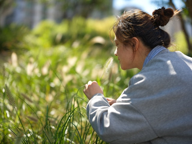 Woman smelling flower
