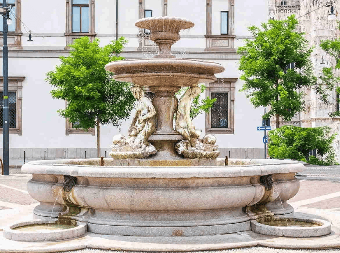 Stone fountain with statues in a city square